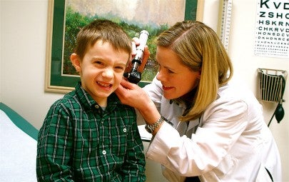 Doctor examining the inside of a child's ear | WWMG