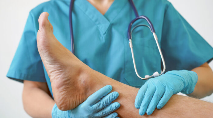 Hand of Doctor holding patient's leg, examination of patients in the hospital. Surgeon, surgical doctor, anesthetist holding leg patient's. Professional ER surgical, healthcare concept.