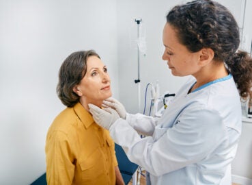 female doctor checking lymph nodes on neck of female patient