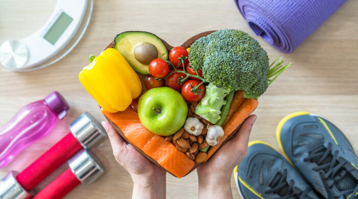 Healthy lifestyle on ketogenic diet, eating clean keto food good health dietary in heart dish with aerobic body exercise, gym workout training class , weight scale and sports shoes in fitness center