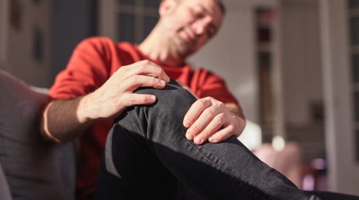 Man with knee pain at home.